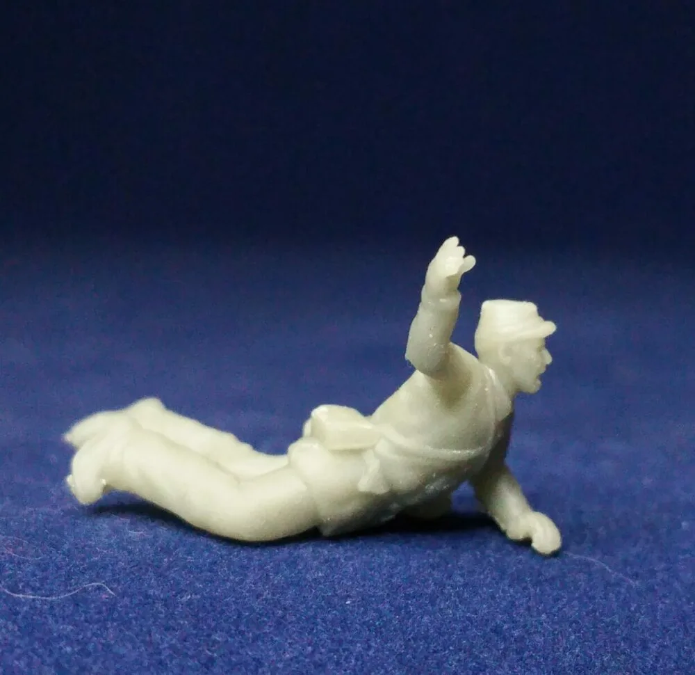 Wounded Union soldier stretching for help in Kepi