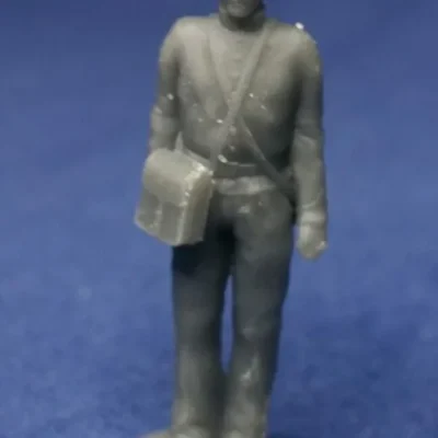 Union canoneer in kepi standing still with bag