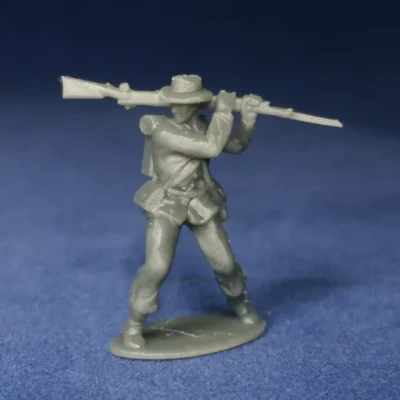 Confederate in sack coat & hat swings musket from shoulder