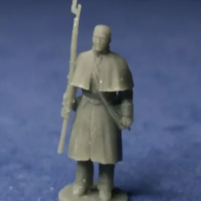 Private in greatcoat at attention bare head