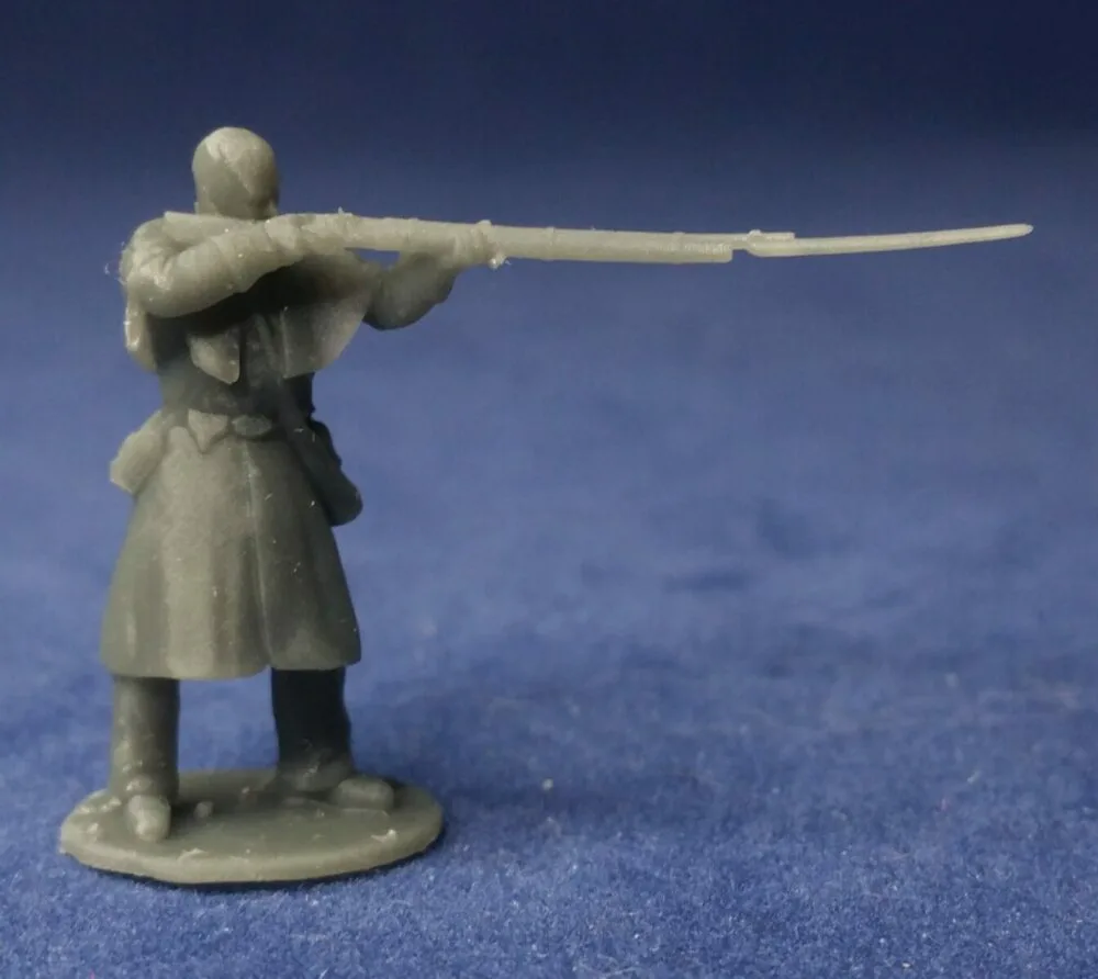 Private in great coat bare head, standing firing