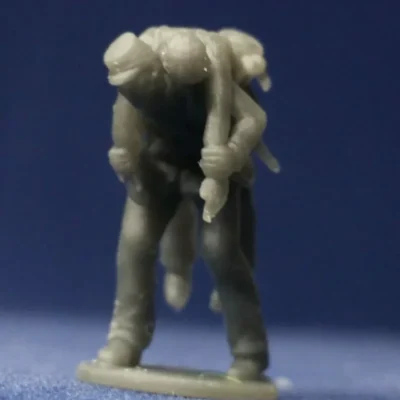 Soldier in kepi carrying wounded comrade