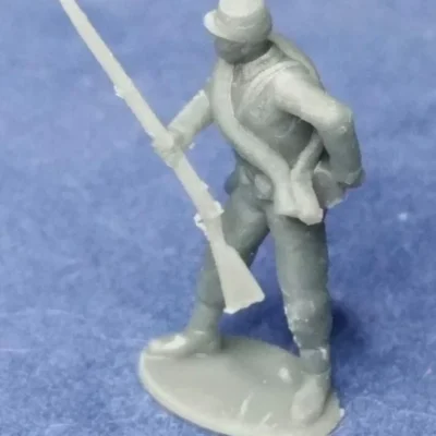 Confederate private in kepi reaching for cartridge