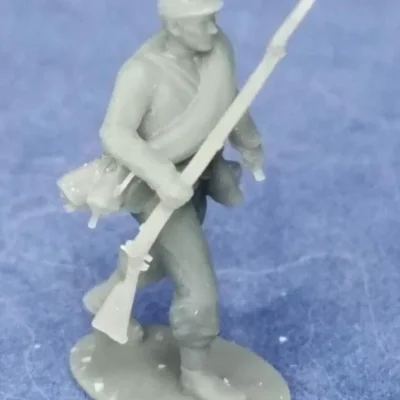 Confederate soldier in kepi walking towards enemy