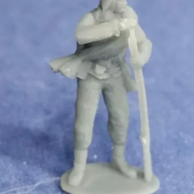 Private in havelock and rolled blanket loading musket