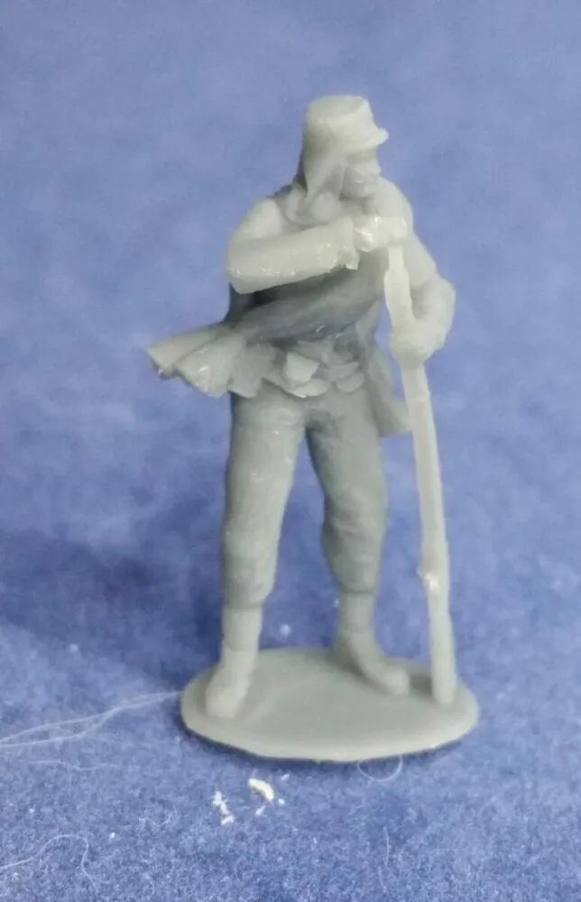 Private in havelock and rolled blanket loading musket