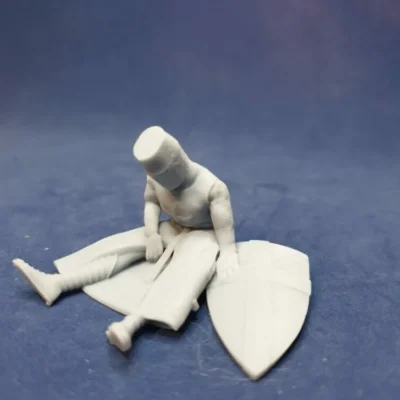 Medieval crusader sitting casualty chainmail, helm and shield AS