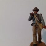 Soldier walking with rifle on shoulder in hat photo review