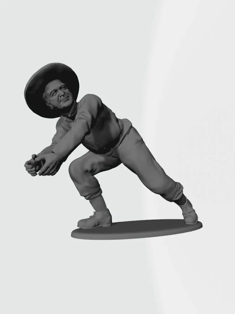 Man patting snowball in hat from snow pile