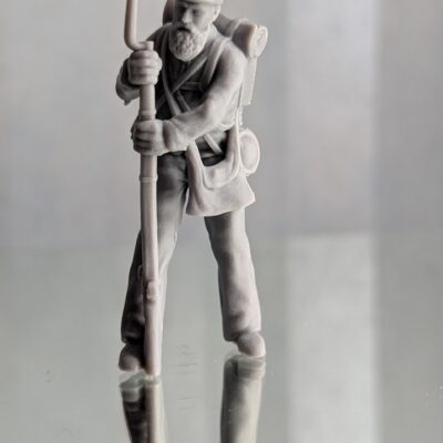 Injured man walking with rifle as stick, beard, shell jacket