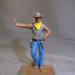 Cowboy leaning hand on wall photo review