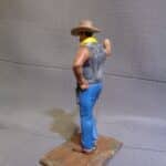 Cowboy leaning hand on wall photo review