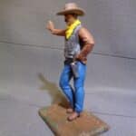 Cowboy leaning hand on wall photo review