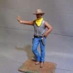 Cowboy leaning hand on wall photo review