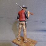 Cowboy with rifle over shoulder photo review