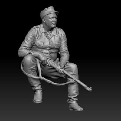 Finnish WWII soldier sitting with rifle and waiting